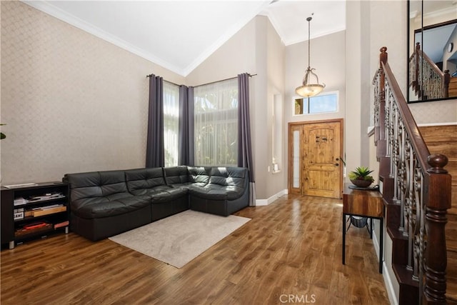 living room featuring crown molding, a healthy amount of sunlight, and wood-type flooring