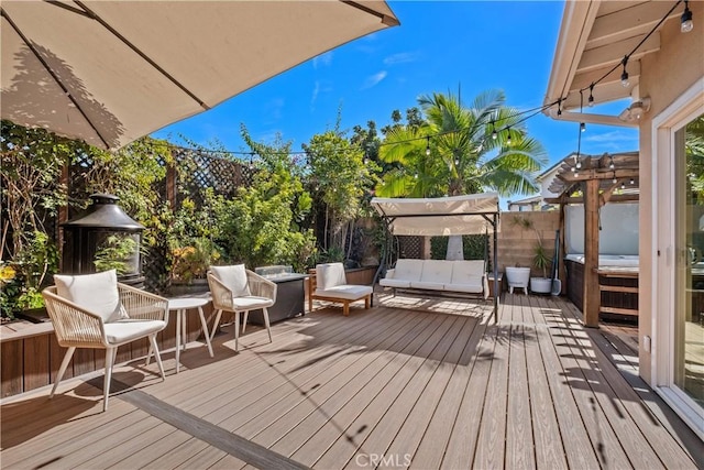 wooden terrace with an outdoor living space