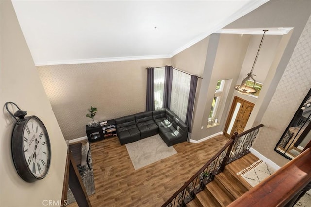 interior space with ornamental molding and hardwood / wood-style floors