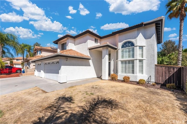 mediterranean / spanish-style home with a garage