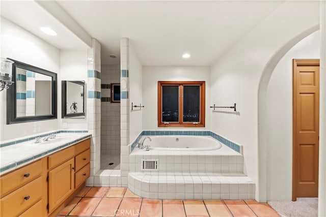 bathroom featuring tile patterned floors, vanity, and separate shower and tub