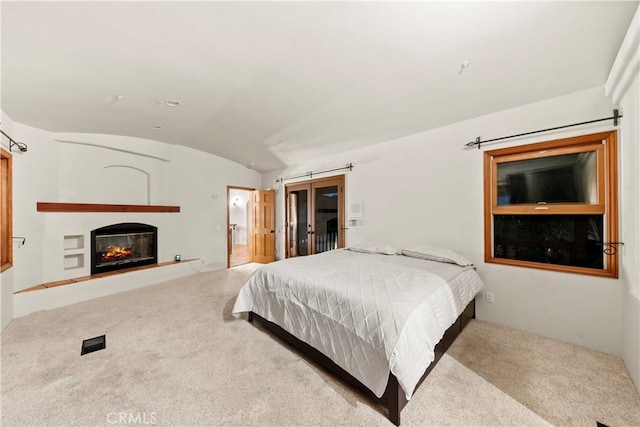 carpeted bedroom with lofted ceiling