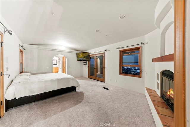 carpeted bedroom with french doors