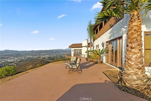 view of patio featuring a mountain view and french doors