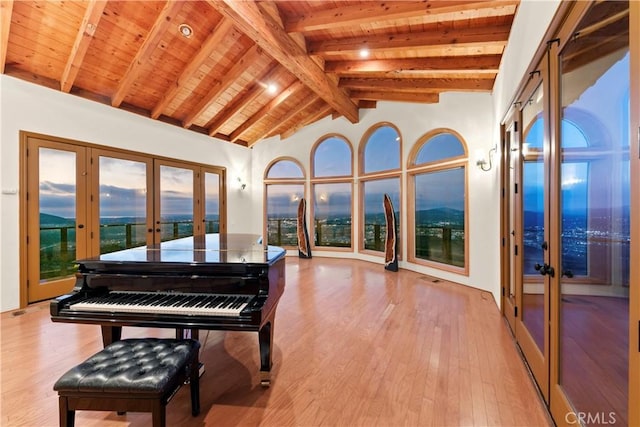 miscellaneous room featuring beam ceiling, french doors, wooden ceiling, high vaulted ceiling, and light wood-type flooring