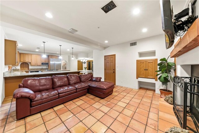 living room featuring light tile patterned floors and sink