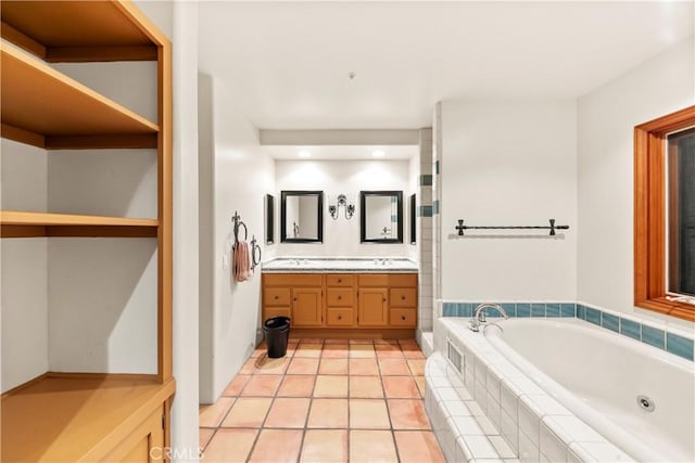 bathroom featuring tile patterned floors, vanity, and a relaxing tiled tub