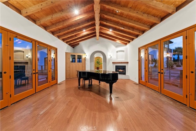 miscellaneous room featuring beamed ceiling, french doors, light hardwood / wood-style flooring, and wood ceiling