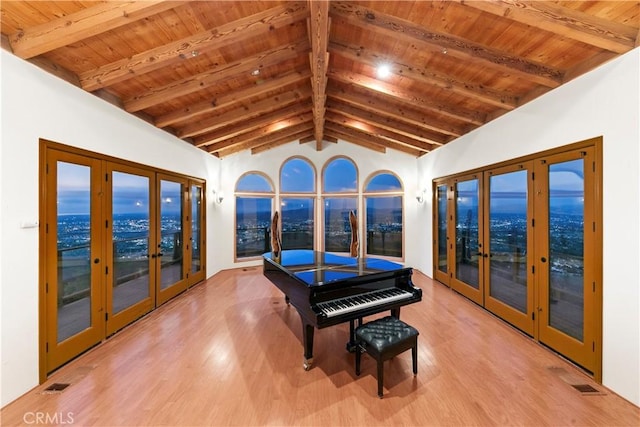 misc room with french doors, vaulted ceiling with beams, light hardwood / wood-style flooring, and wooden ceiling