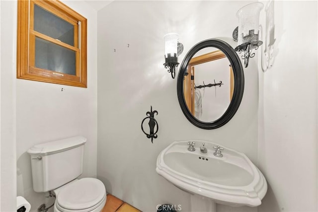 bathroom featuring tile patterned flooring, toilet, and sink