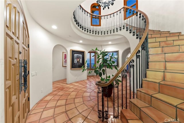 entrance foyer with tile patterned floors and a high ceiling