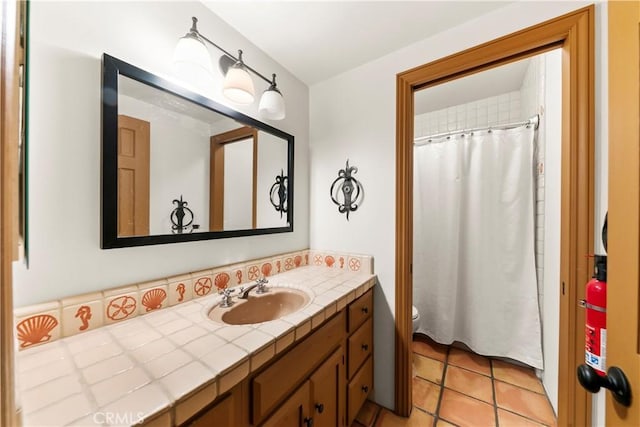 bathroom featuring tile patterned floors, vanity, and toilet