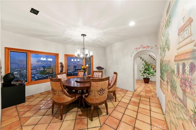 tiled dining area with a notable chandelier