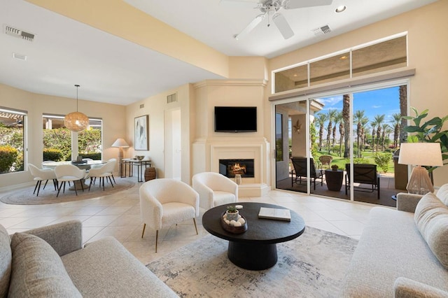 tiled living room featuring ceiling fan