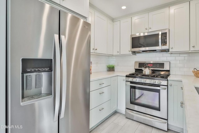 kitchen featuring white cabinetry, decorative backsplash, and stainless steel appliances