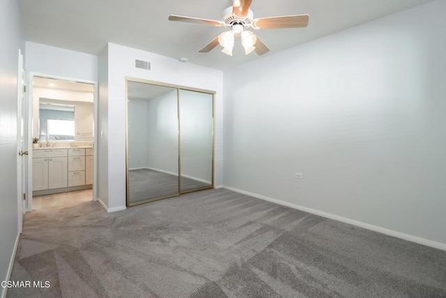 unfurnished bedroom with light carpet, a closet, and ceiling fan