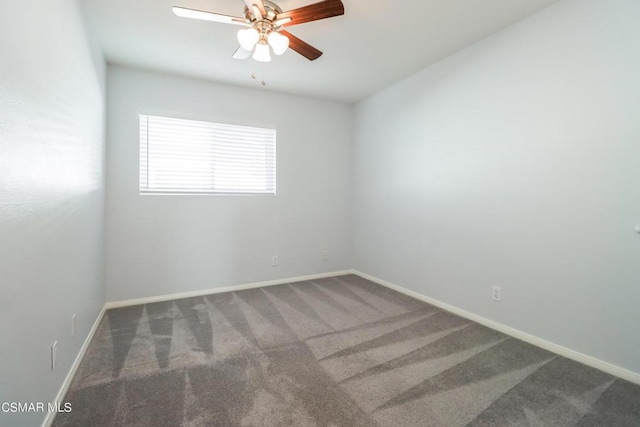 empty room with dark carpet and ceiling fan