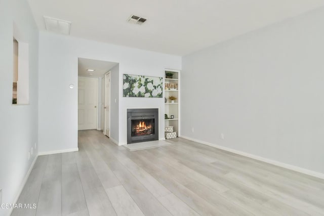 unfurnished living room with light hardwood / wood-style flooring