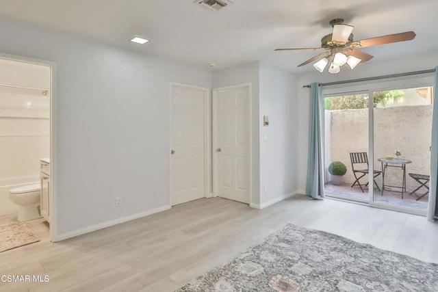 bedroom with light hardwood / wood-style flooring, access to outside, and ensuite bathroom