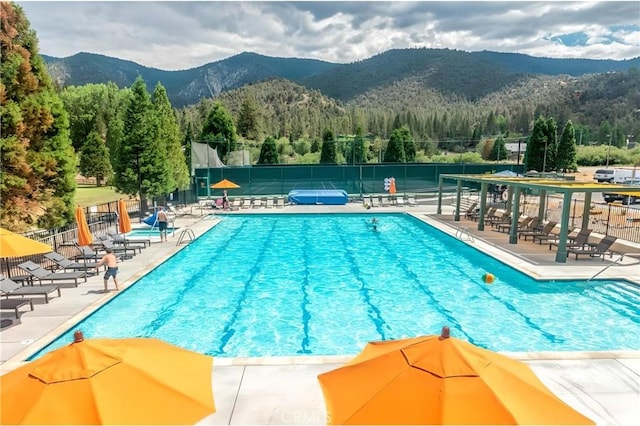 view of pool featuring a mountain view and a patio area