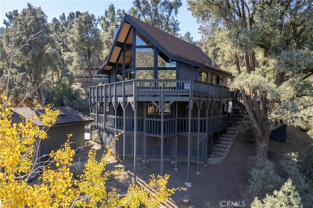 rear view of house featuring a deck