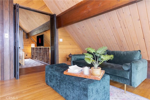 living room with hardwood / wood-style floors, vaulted ceiling with beams, wooden ceiling, and wooden walls