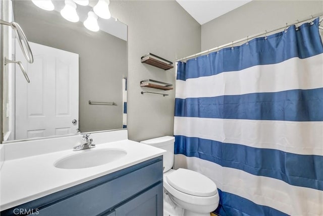 bathroom with vanity, a shower with shower curtain, and toilet