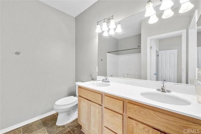 bathroom featuring tile patterned floors, vanity, toilet, and walk in shower