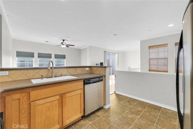 kitchen with decorative backsplash, appliances with stainless steel finishes, dark tile patterned floors, ceiling fan, and sink