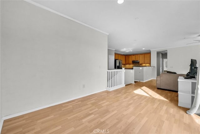 unfurnished living room featuring ceiling fan, light hardwood / wood-style flooring, and ornamental molding