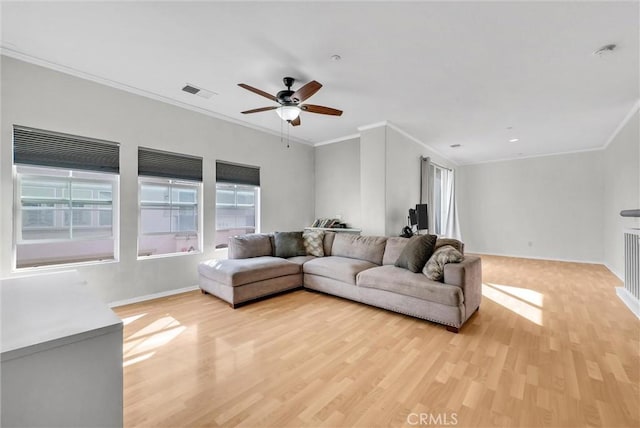 living room with light hardwood / wood-style flooring, ceiling fan, and ornamental molding