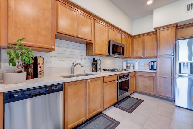 kitchen with sink, backsplash, and stainless steel appliances