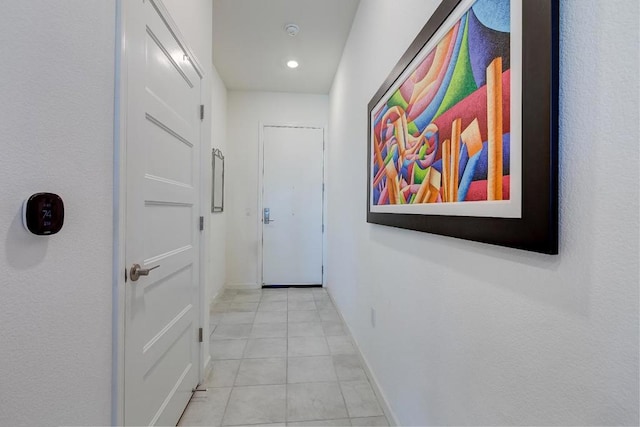 hall featuring light tile patterned floors