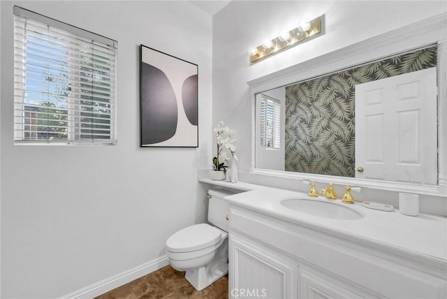 bathroom featuring tile patterned flooring, vanity, and toilet