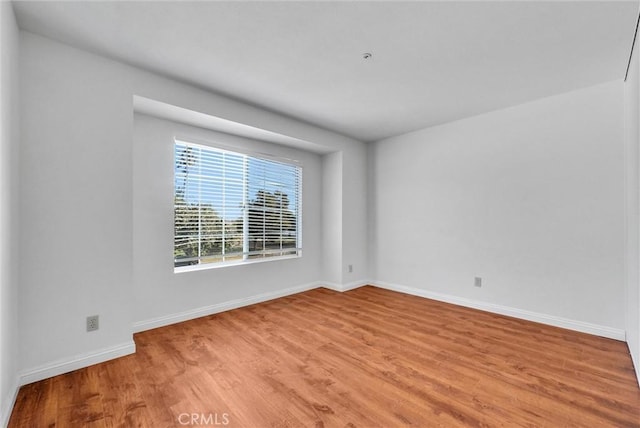 spare room featuring light hardwood / wood-style floors