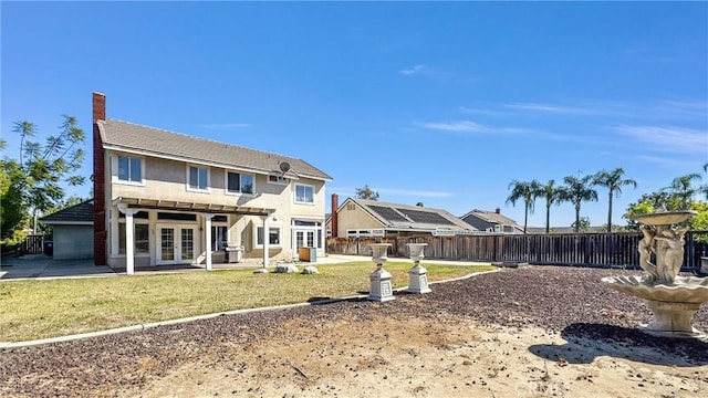 back of house featuring a yard, a patio, and french doors