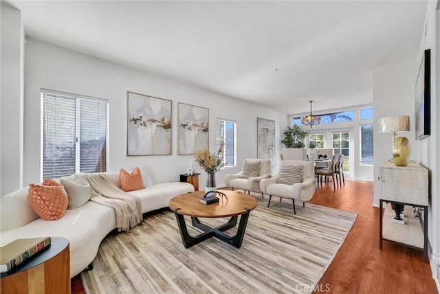 living room featuring hardwood / wood-style flooring and an inviting chandelier