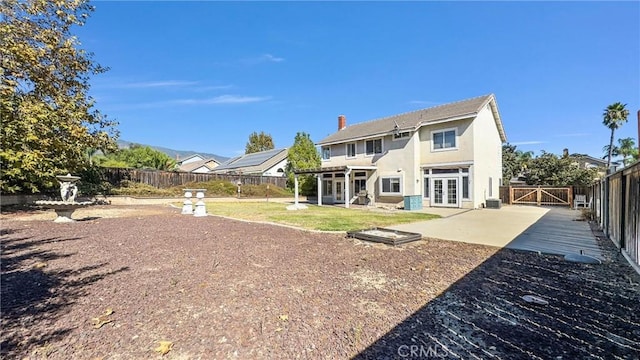 back of property featuring french doors and a patio