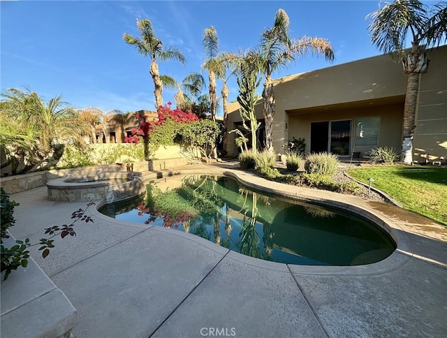 view of swimming pool with an in ground hot tub