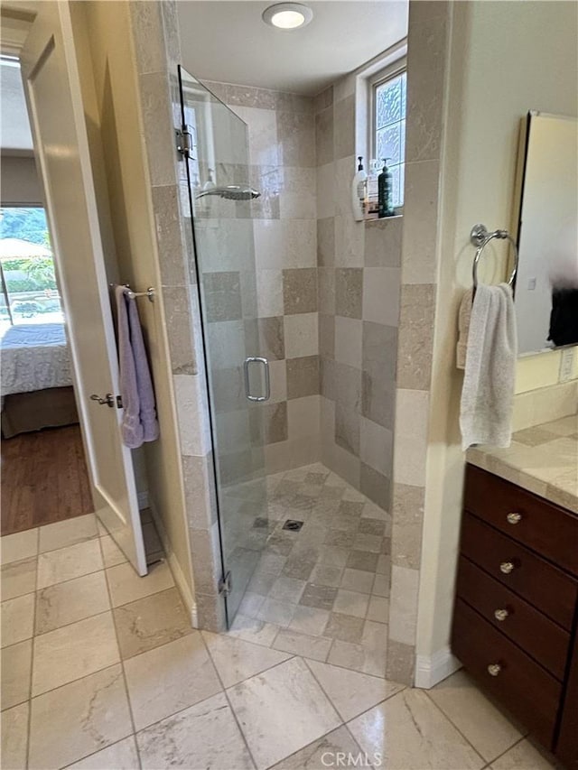 bathroom with an enclosed shower and vanity