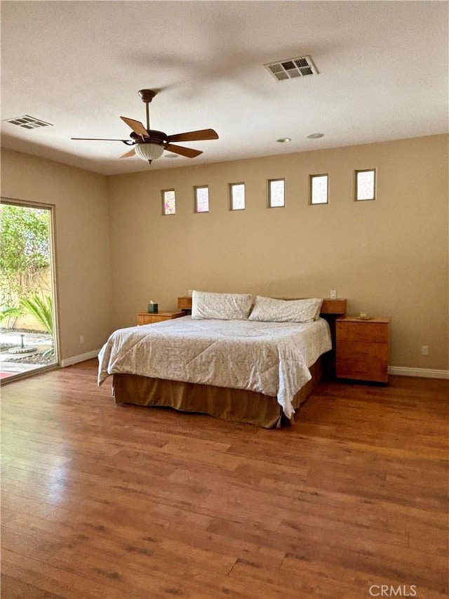 bedroom featuring ceiling fan, access to exterior, and hardwood / wood-style floors