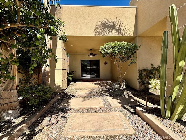 property entrance with ceiling fan and a patio area