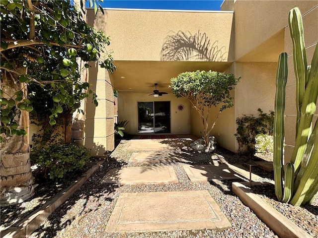 view of exterior entry with ceiling fan