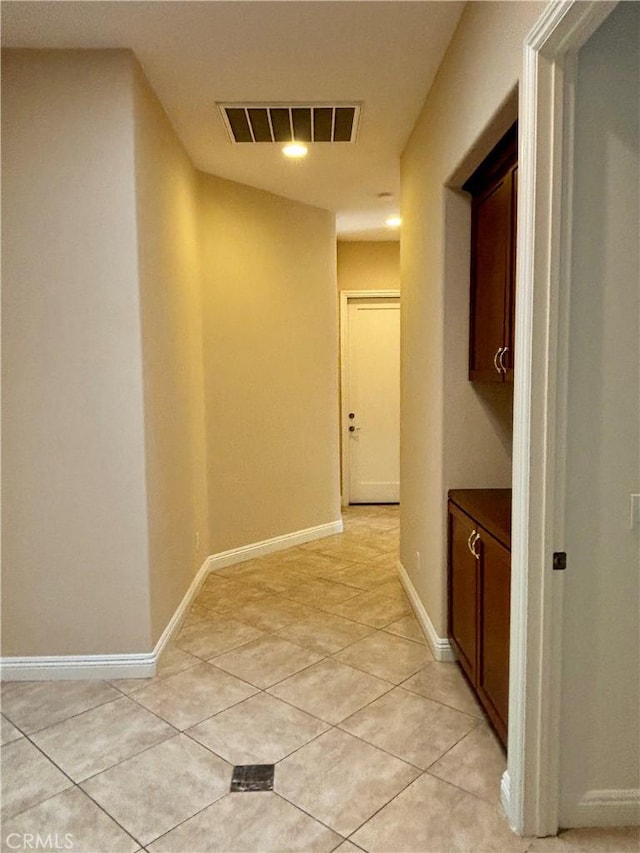 corridor featuring light tile patterned flooring