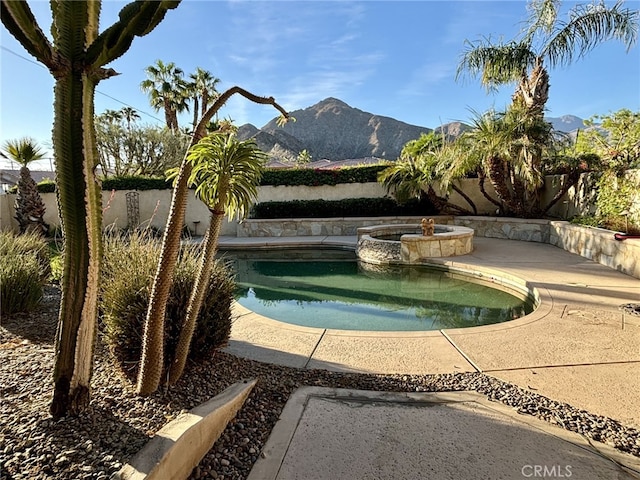 view of pool featuring a mountain view and an in ground hot tub