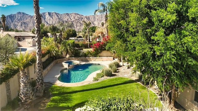 view of swimming pool featuring a mountain view and a yard