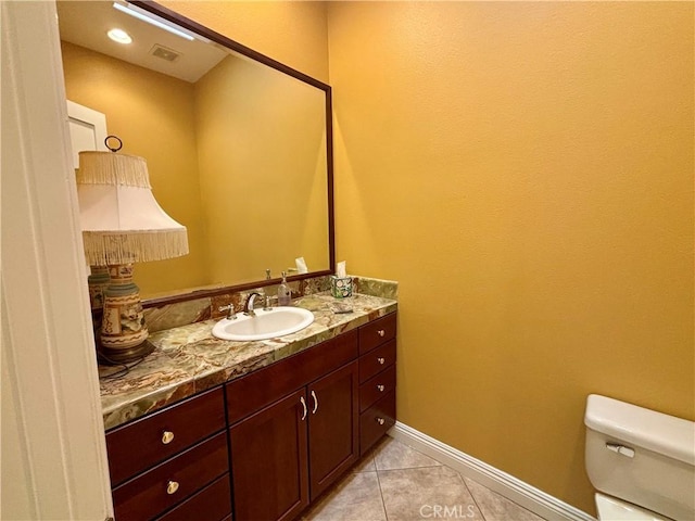 bathroom featuring vanity, toilet, and tile patterned flooring