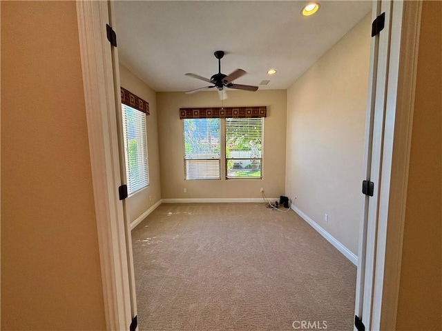 unfurnished room featuring carpet floors and ceiling fan