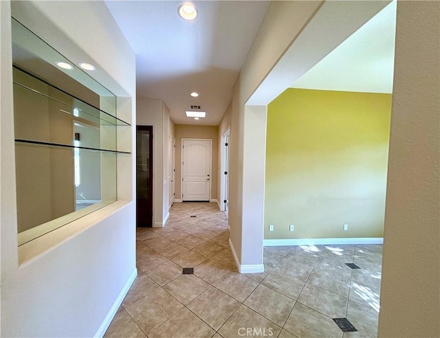 hallway featuring light tile patterned floors