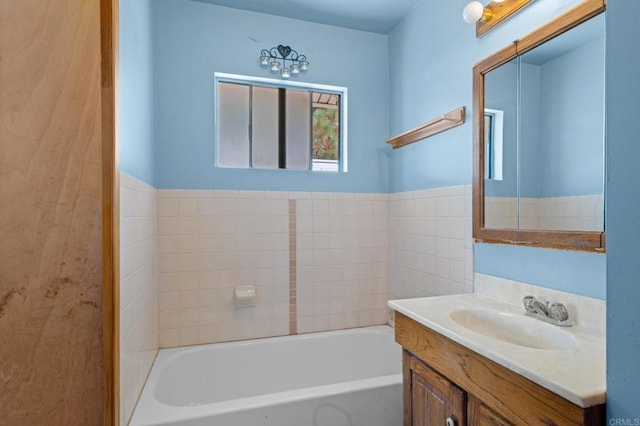 bathroom featuring vanity and a tub to relax in